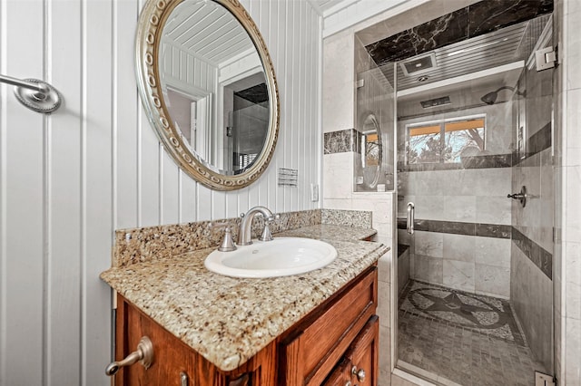 bathroom featuring vanity and a tile shower