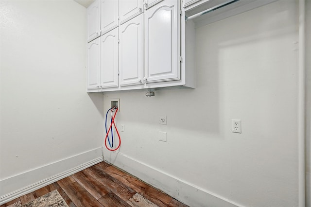 laundry room featuring dark hardwood / wood-style flooring, hookup for a washing machine, and cabinets