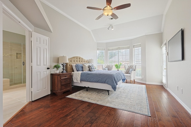 bedroom featuring crown molding, ensuite bath, wood-type flooring, and vaulted ceiling