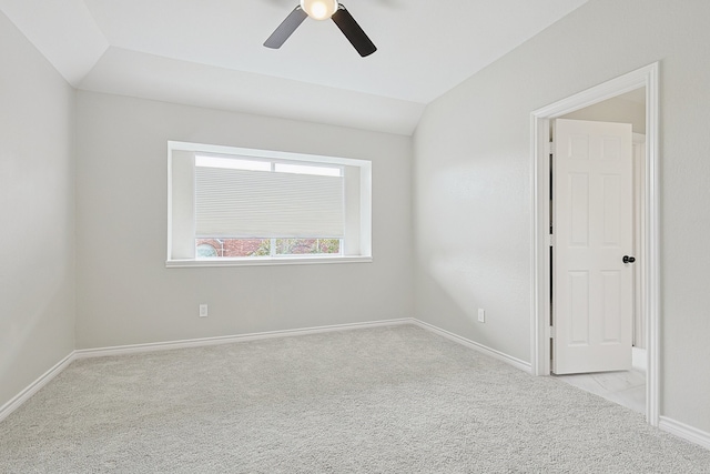 empty room with vaulted ceiling, light carpet, and ceiling fan