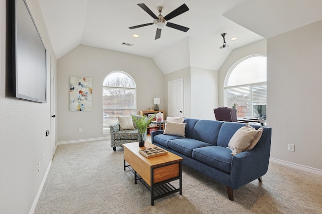 living room featuring light carpet, lofted ceiling, and a healthy amount of sunlight