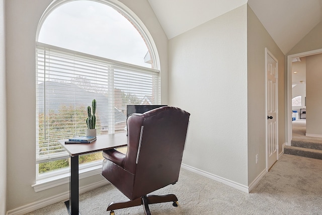 home office with light carpet and vaulted ceiling