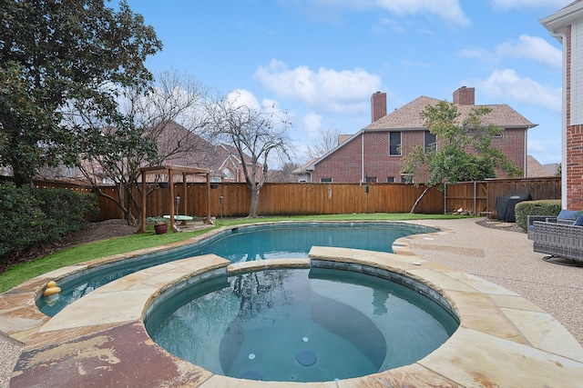 view of swimming pool with an in ground hot tub