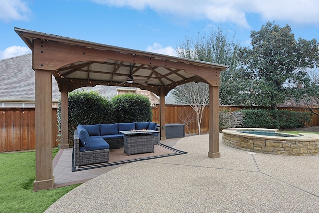 view of patio / terrace with a gazebo, an outdoor hangout area, ceiling fan, and an in ground hot tub