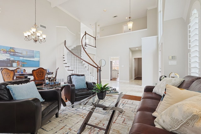 living room featuring a high ceiling, light tile patterned floors, and a notable chandelier