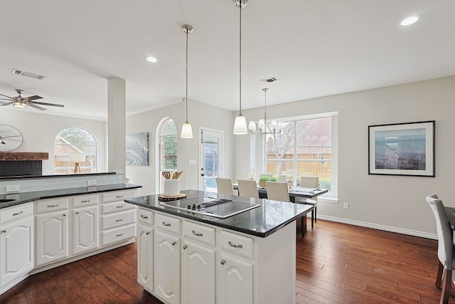 kitchen with white cabinetry, decorative light fixtures, dark hardwood / wood-style floors, a kitchen island, and black electric stovetop