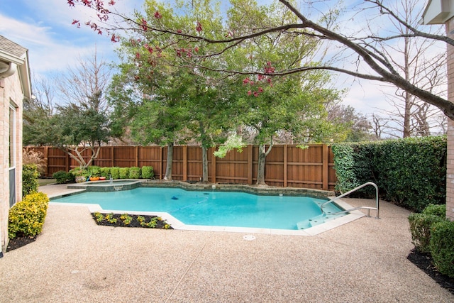 view of swimming pool featuring a patio and an in ground hot tub