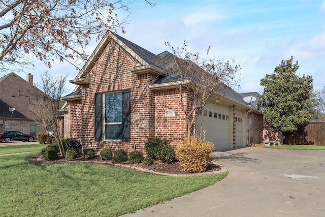 view of side of property featuring a garage and a lawn