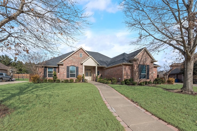 view of property exterior featuring an attached garage, a yard, concrete driveway, and brick siding