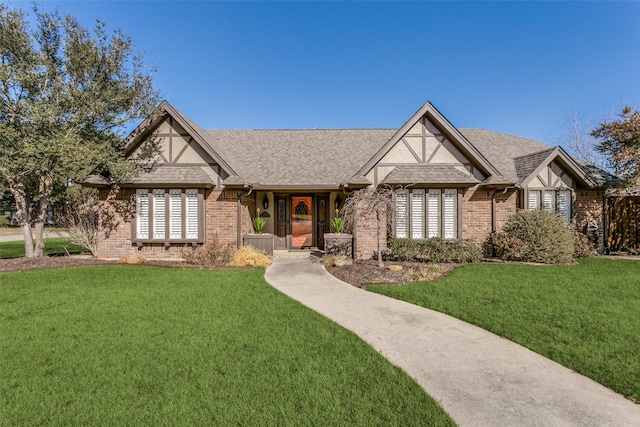 tudor-style house featuring a front yard