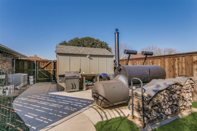 view of patio featuring cooling unit and a storage shed