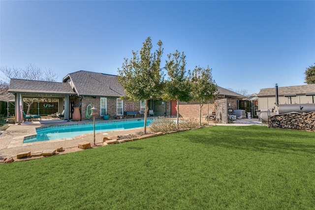 view of swimming pool with a patio area and a lawn