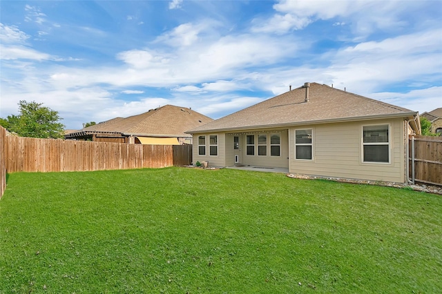 back of house with a yard