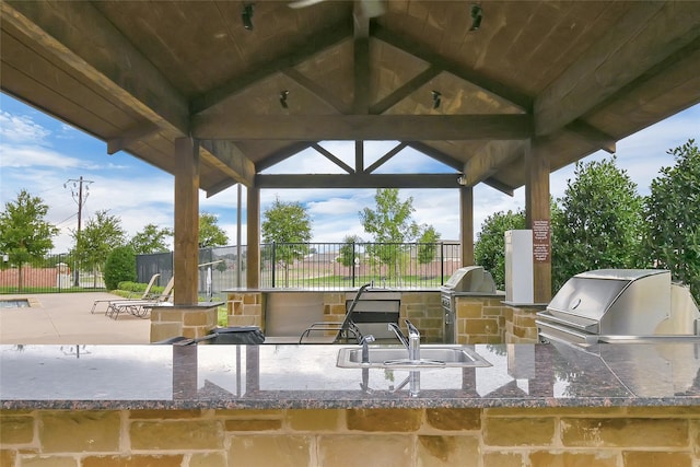 view of patio / terrace featuring area for grilling, sink, and a gazebo