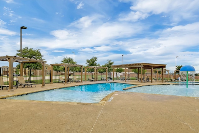 view of swimming pool featuring pool water feature, a patio area, and a pergola