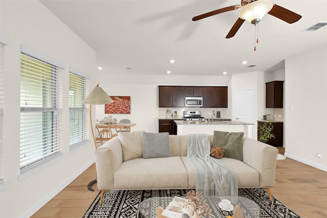 living room with sink and light wood-type flooring