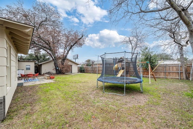 view of yard featuring a playground, a patio area, and a trampoline