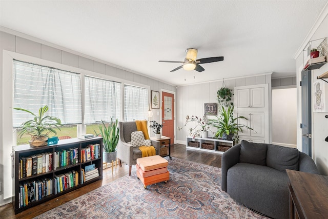 interior space with dark hardwood / wood-style flooring, ornamental molding, and ceiling fan