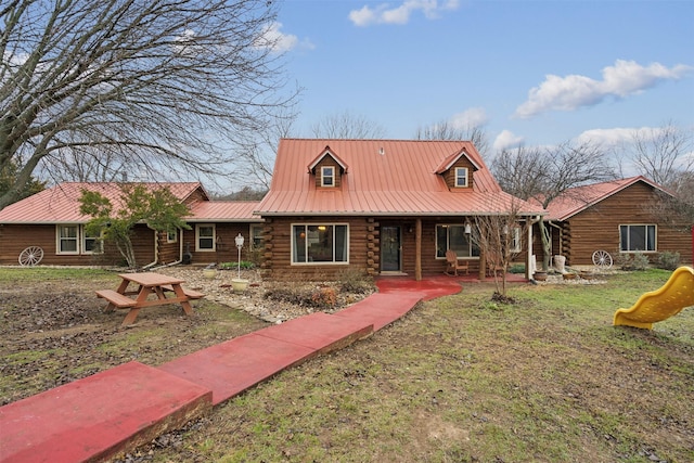 log-style house with a playground and a front yard