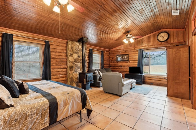 bedroom with lofted ceiling, light tile patterned floors, log walls, wooden ceiling, and a wood stove