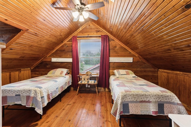 bedroom with hardwood / wood-style floors, vaulted ceiling, wooden ceiling, and wood walls