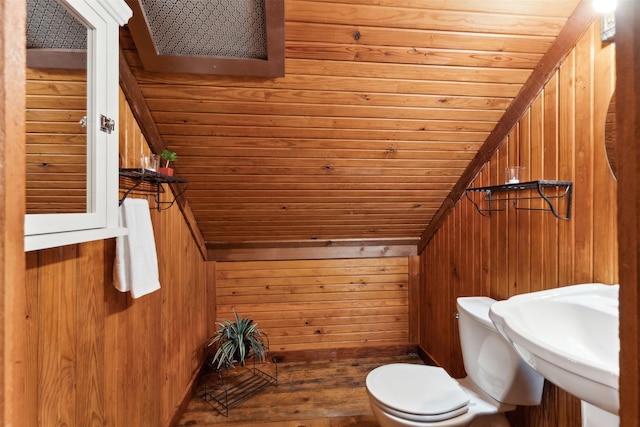 bathroom featuring toilet, wooden walls, vaulted ceiling, and wooden ceiling