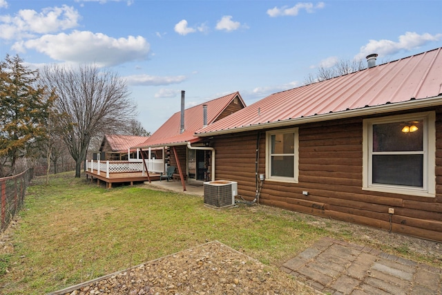 back of house featuring cooling unit, a yard, and a deck