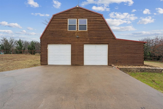 view of side of property with a garage and an outdoor structure