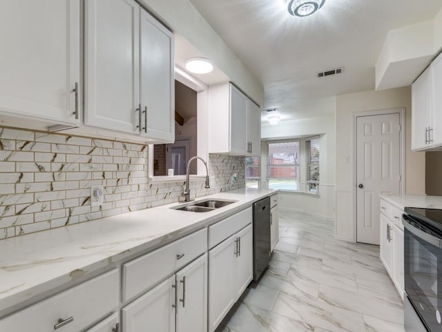 kitchen featuring white cabinetry, sink, stainless steel appliances, and light stone countertops