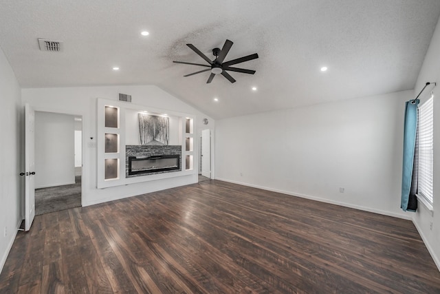 unfurnished living room with dark wood-type flooring, visible vents, ceiling fan, and lofted ceiling