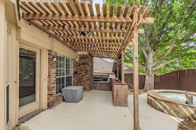 view of patio with a pergola, an outdoor hot tub, grilling area, fence, and exterior kitchen