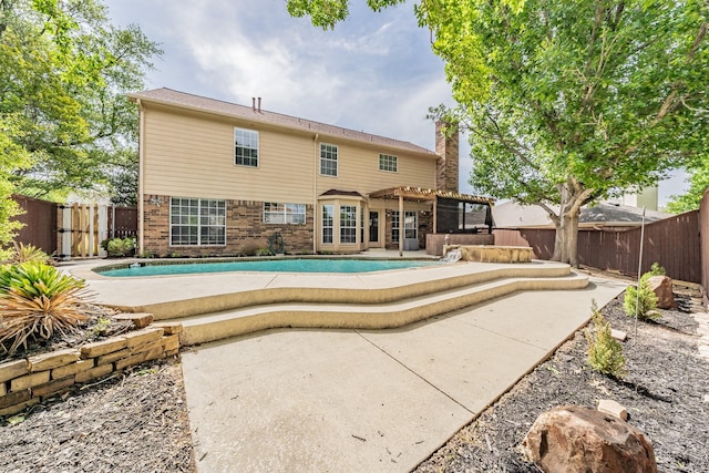 back of house with a patio area, a fenced backyard, a fenced in pool, and a pergola