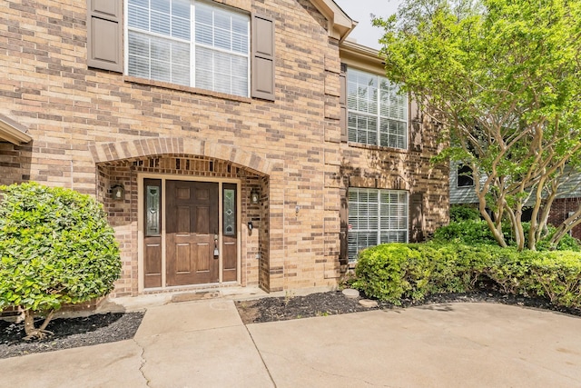 property entrance with brick siding