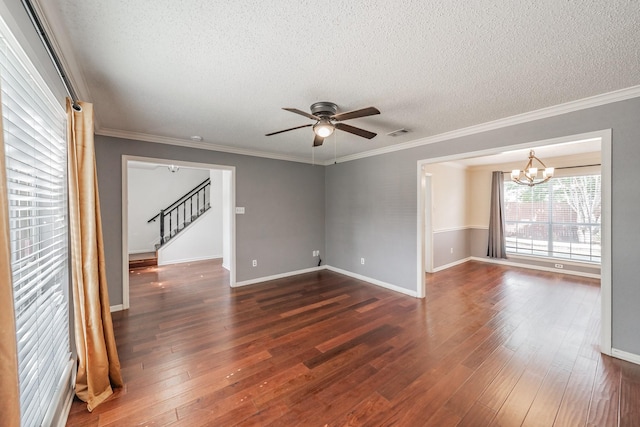 empty room with a textured ceiling, ceiling fan with notable chandelier, visible vents, and stairs