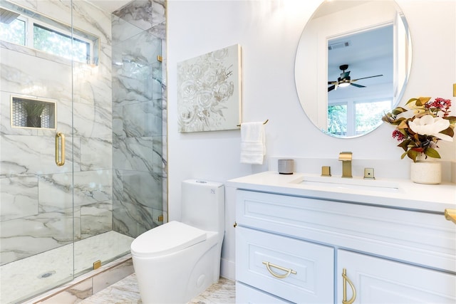 bathroom featuring a shower with door, vanity, plenty of natural light, and toilet