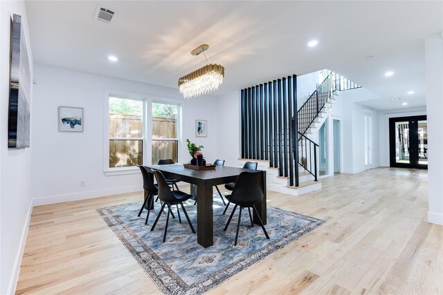 kitchen with white cabinets, sink, extractor fan, and premium appliances