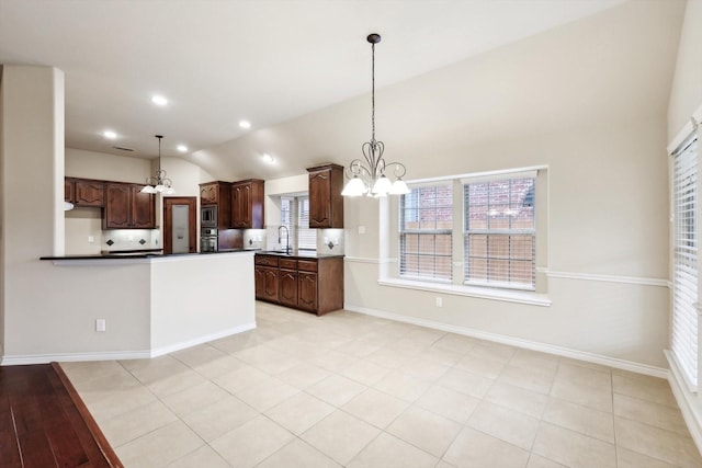 kitchen featuring pendant lighting, sink, dark brown cabinets, and appliances with stainless steel finishes