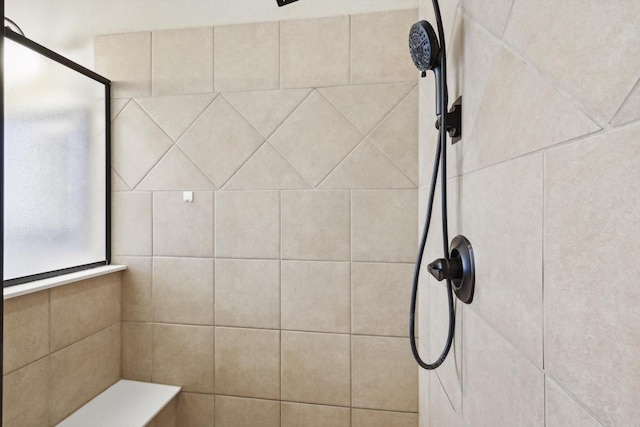 room details featuring a tile shower