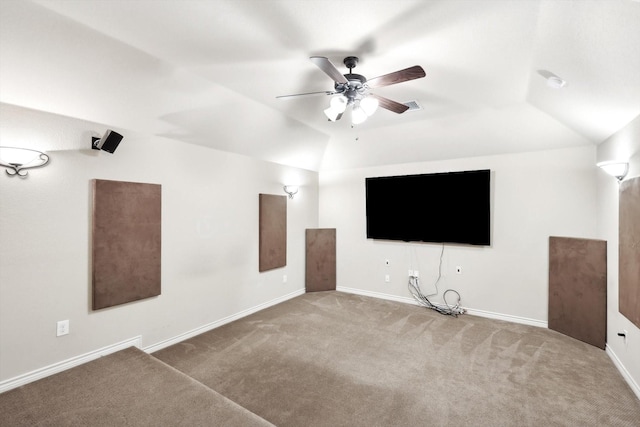 carpeted cinema room featuring lofted ceiling and ceiling fan