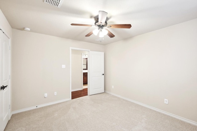 unfurnished bedroom with light carpet and ceiling fan