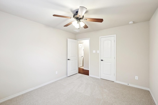 unfurnished bedroom featuring ceiling fan and light carpet