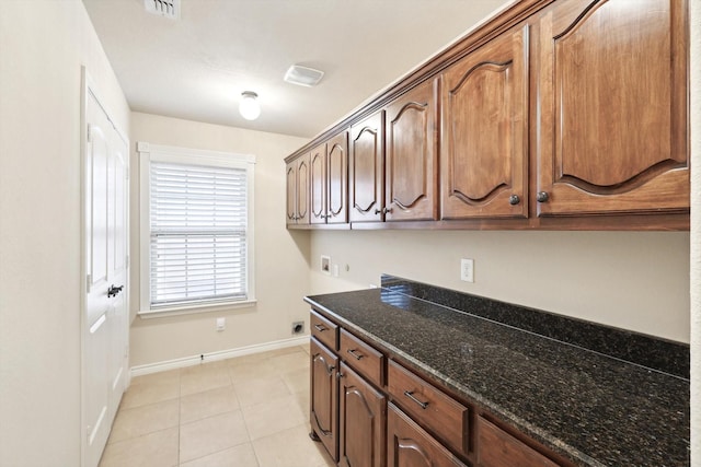 laundry area featuring hookup for a washing machine, light tile patterned flooring, cabinets, and hookup for an electric dryer