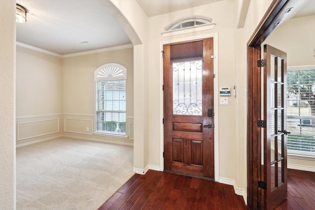 foyer featuring crown molding and dark hardwood / wood-style floors