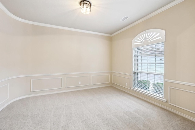 carpeted spare room featuring crown molding