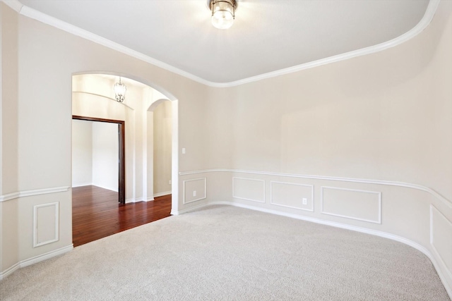 carpeted empty room with crown molding