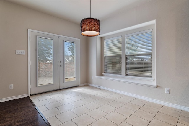 interior space featuring light tile patterned flooring and french doors