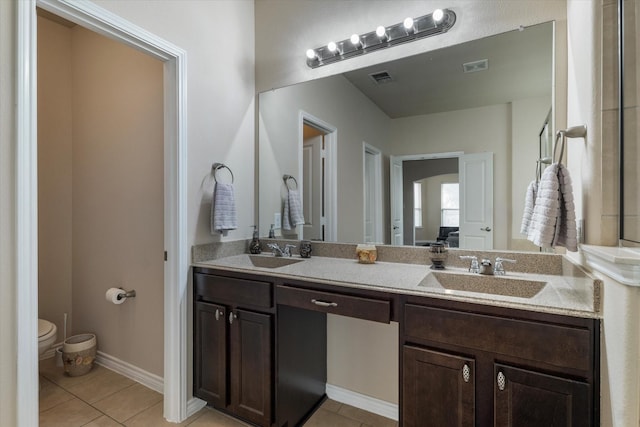 bathroom with vanity, tile patterned floors, and toilet