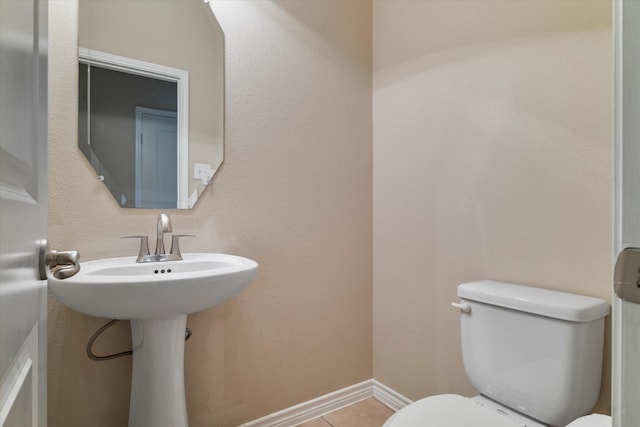 bathroom featuring tile patterned flooring and toilet