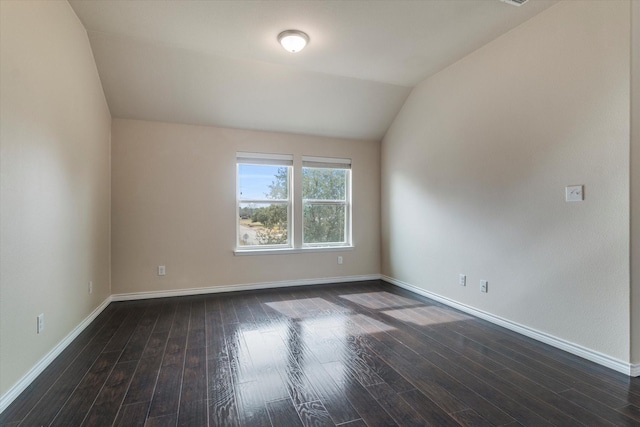 unfurnished room with lofted ceiling and dark hardwood / wood-style flooring