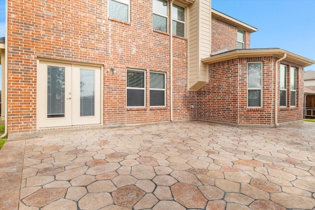 rear view of house with a patio area and french doors